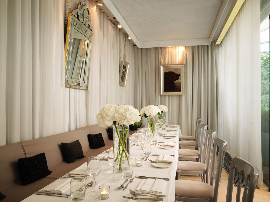 terrace room with long dining table with white flowers