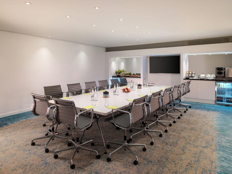 boardroom with large table and grey chairs