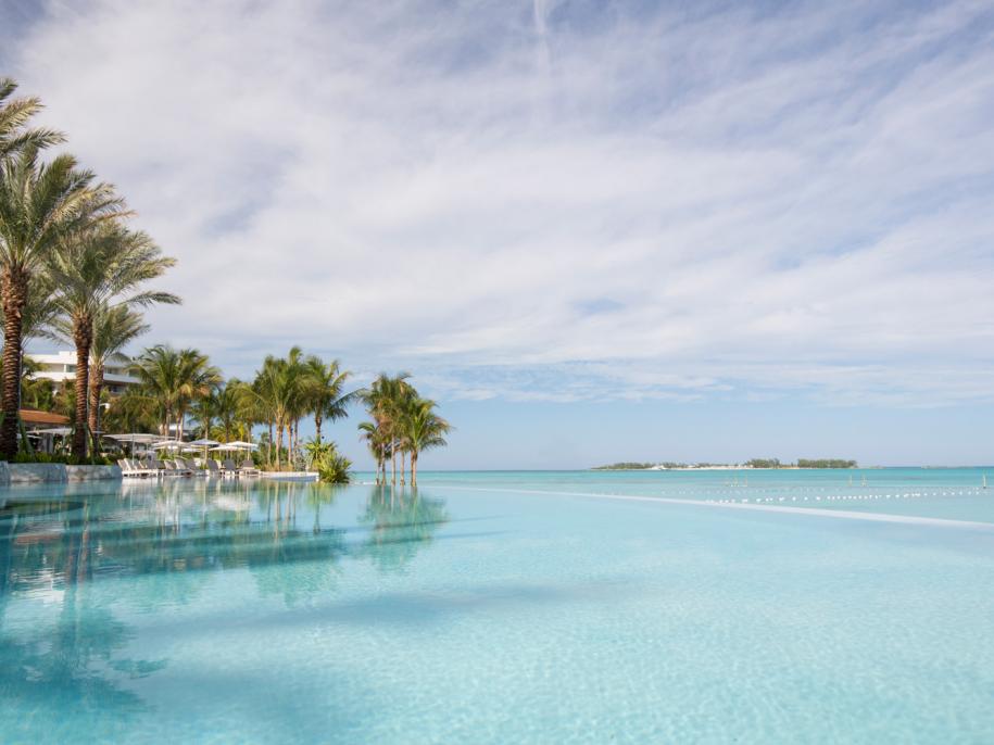 infinity pool in front of tropical beach