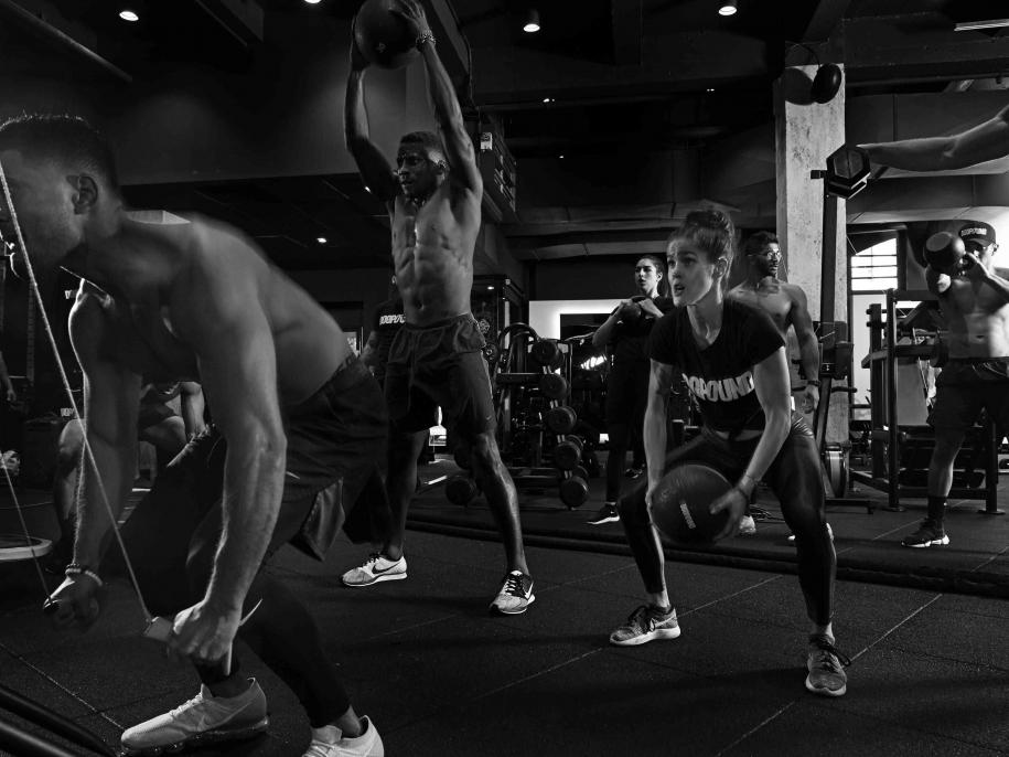 people working out in gym black and white