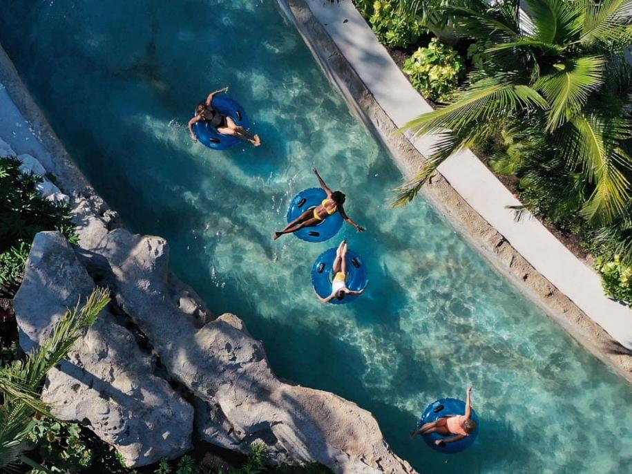 aerial of a family floating in a river pool