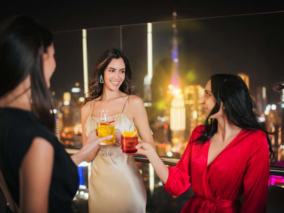 three women having a drink on the balcony