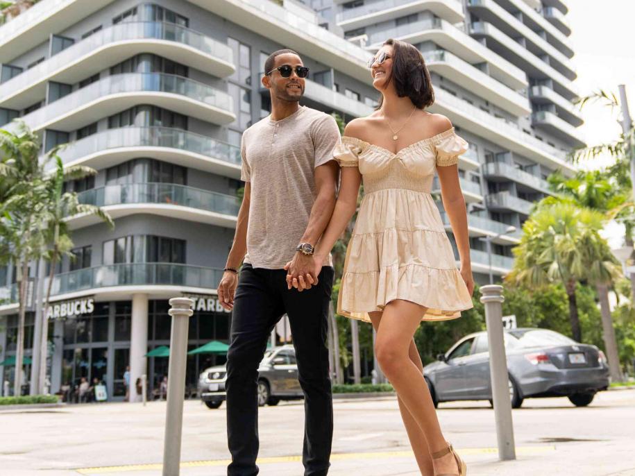 couple walking outside the hotel holding hands