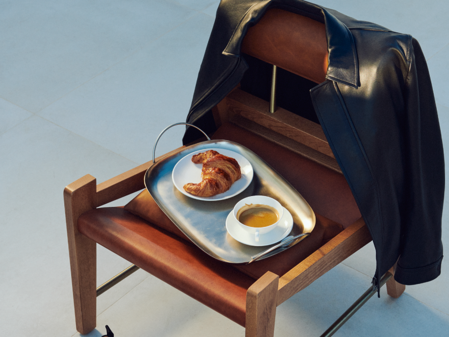 chair with a tray of breakfast food and drinks on it