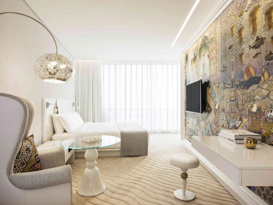 superior room with living area, bed and balcony