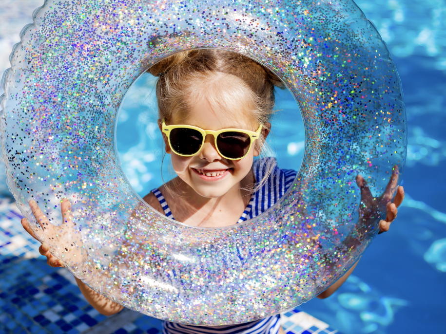 Little kid in pool with a floatie