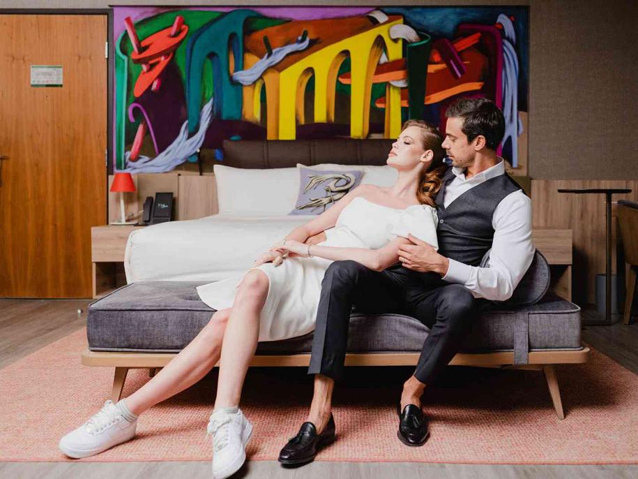 two people in a hotel room 