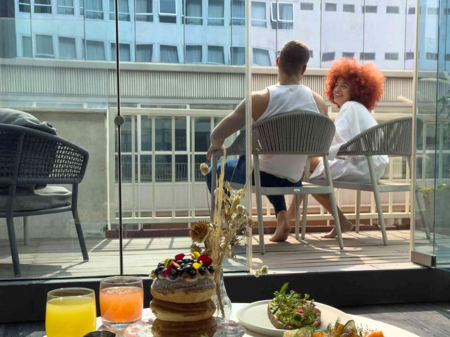 Man and woman look at each other balcony 