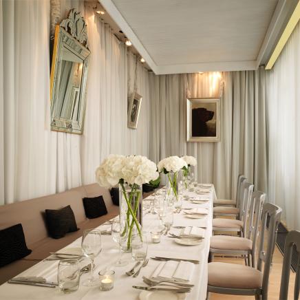 terrace room with long dining table with white flowers
