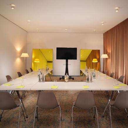 U shaped conference table facing monitor