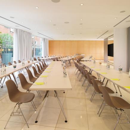 long rows of tables with chairs set up for presentation