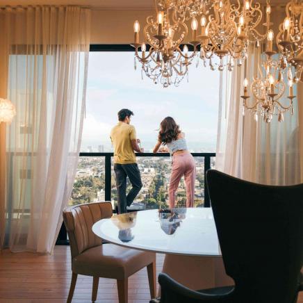 two people looking outside from a hotel patio