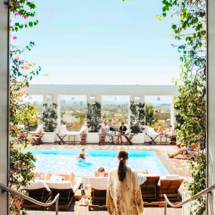 woman walking towards and outside pool
