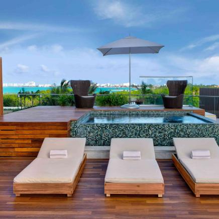 Patio with Jacuzzi overlooking a body of water