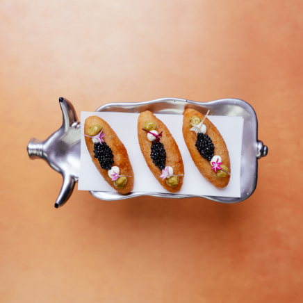 biscuits with caviar on a pig shaped serving dish