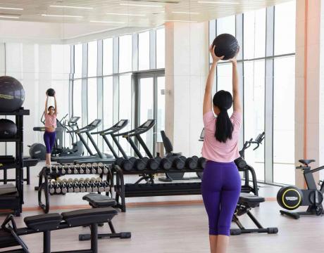 Woman balancing with a medicine ball 