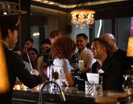 Men and women drinking at a bar