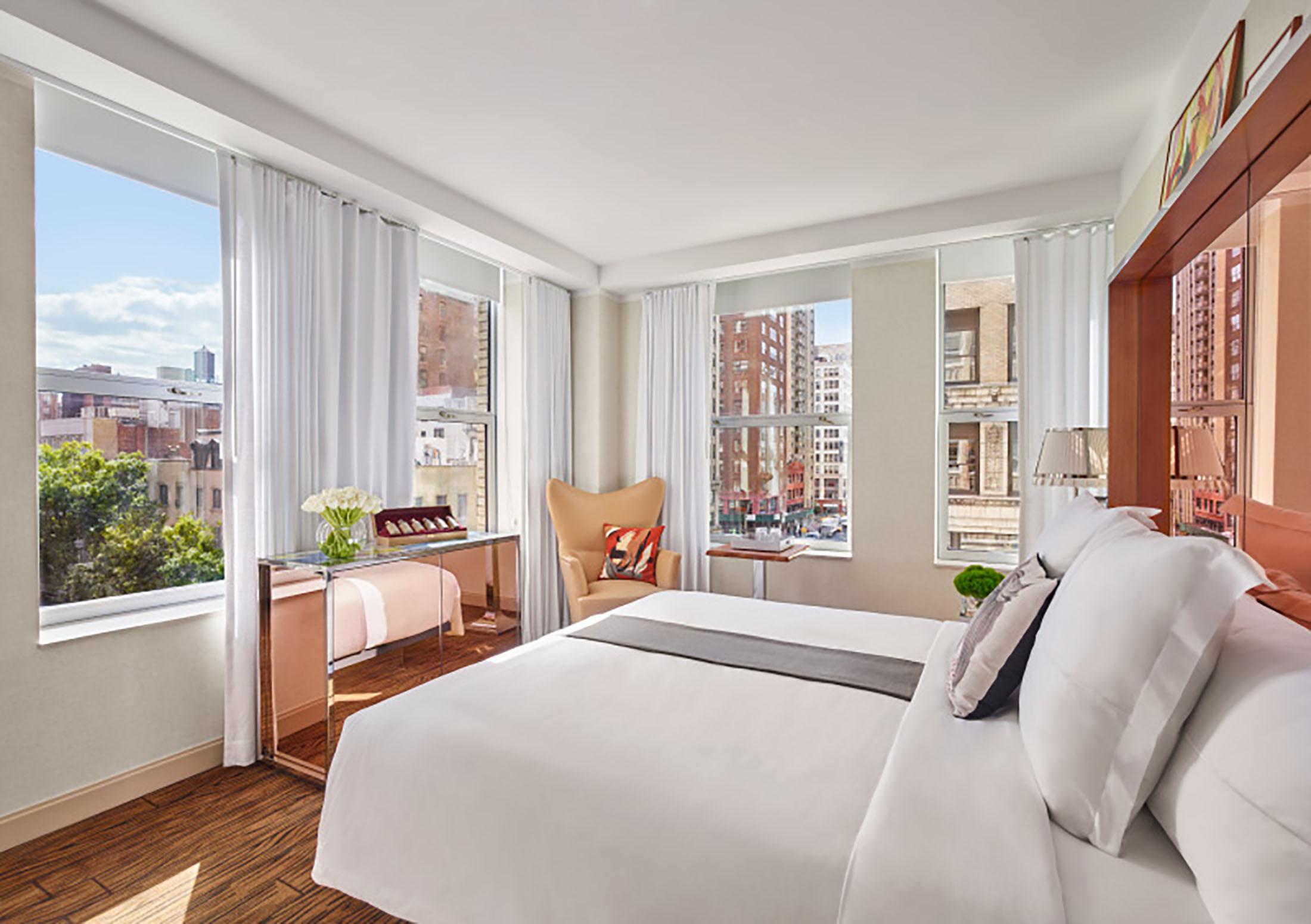 A bright hotel room overlooking the city