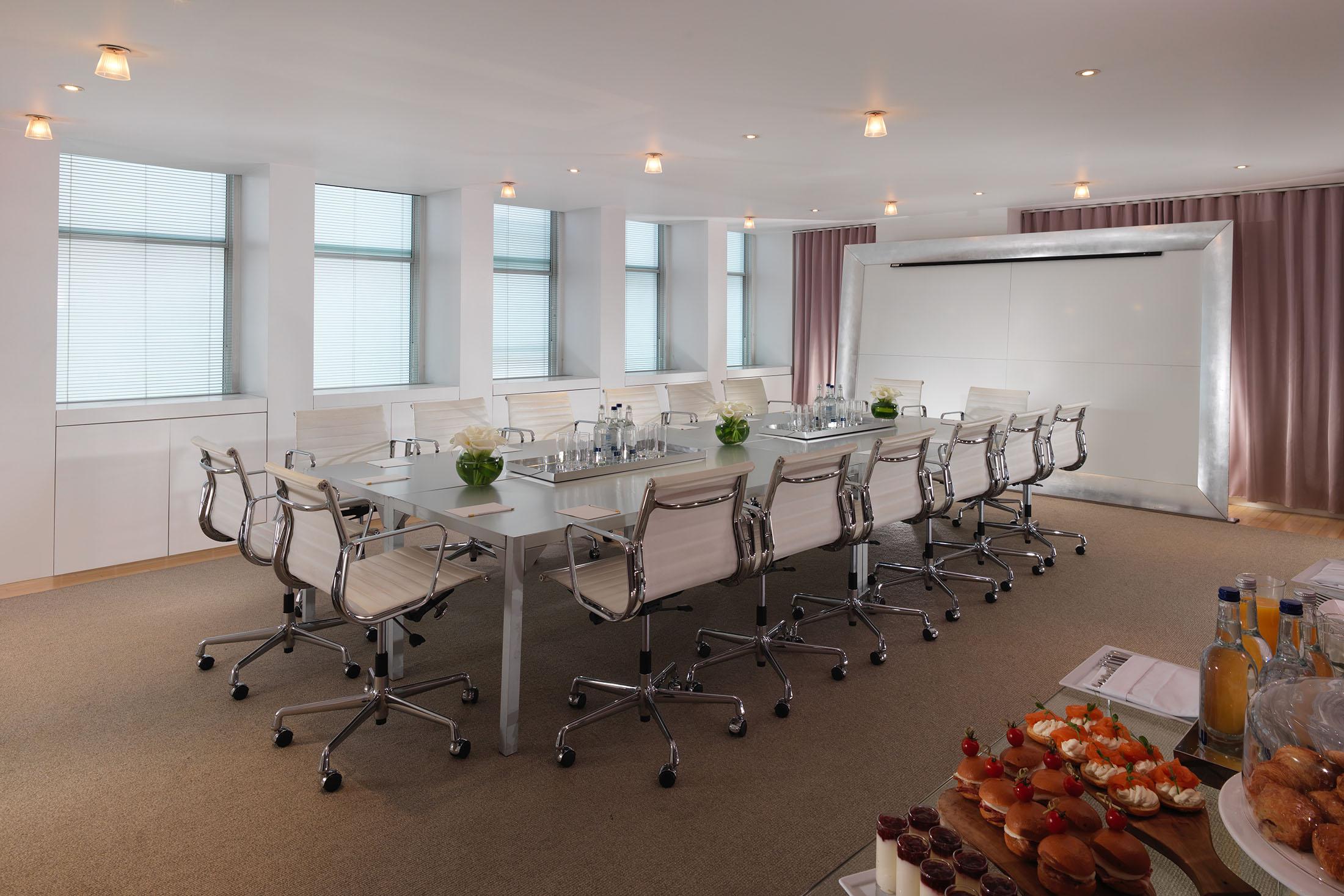boardroom with white chairs 