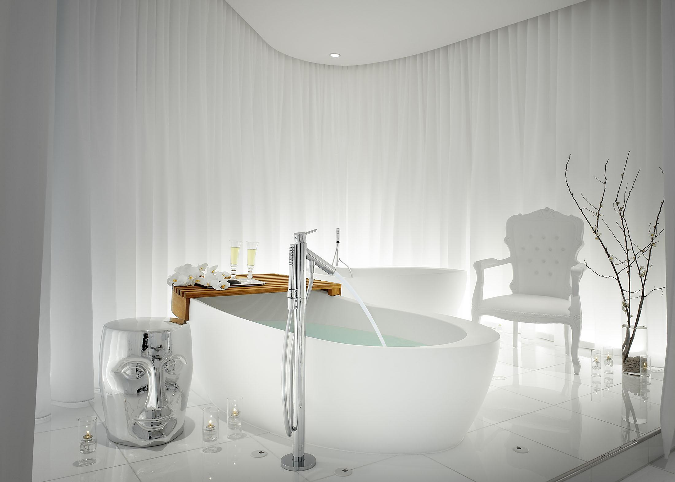 A tub being filled in a serene white spa