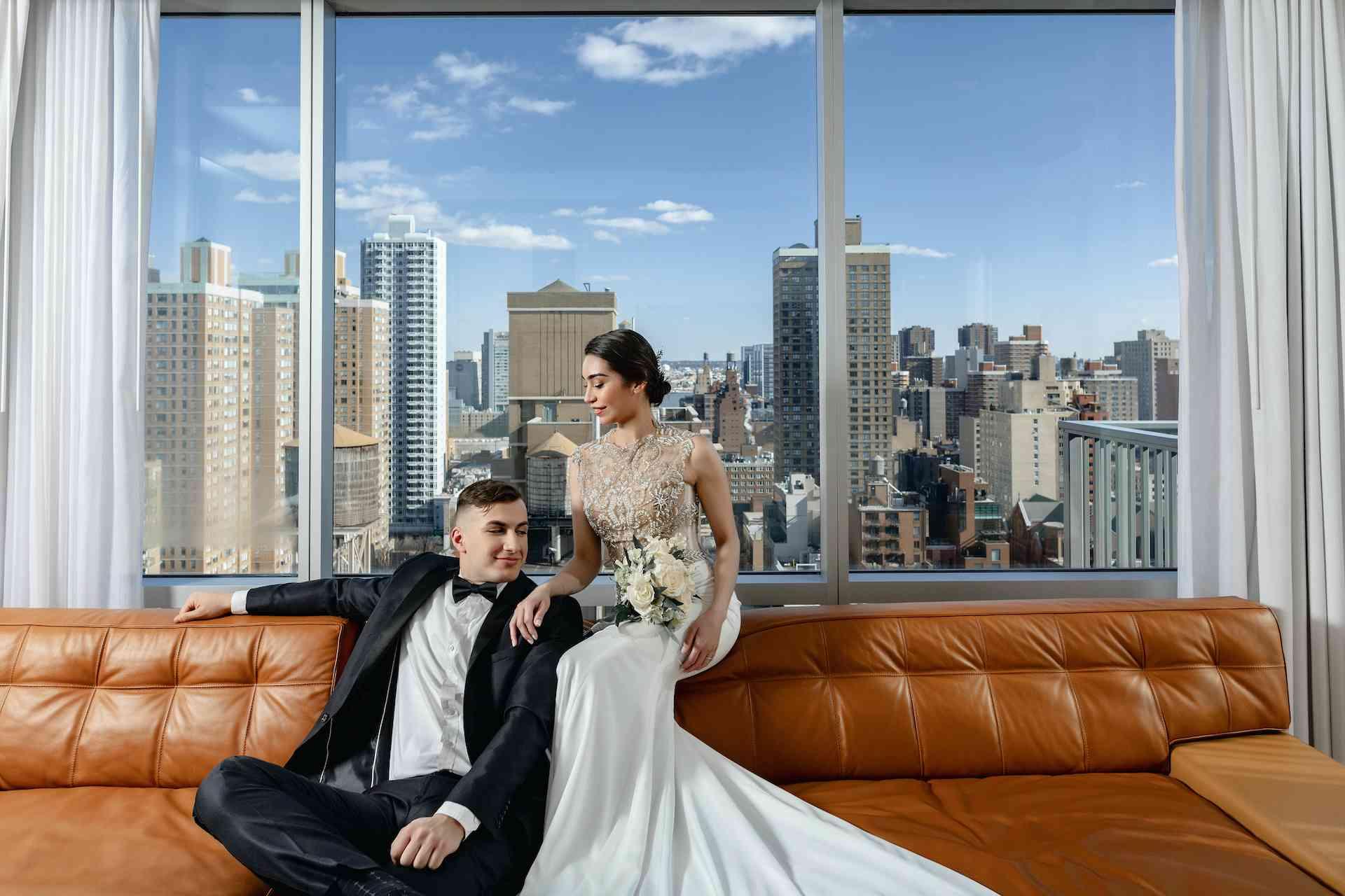 bridge and groom on a couch with NY view