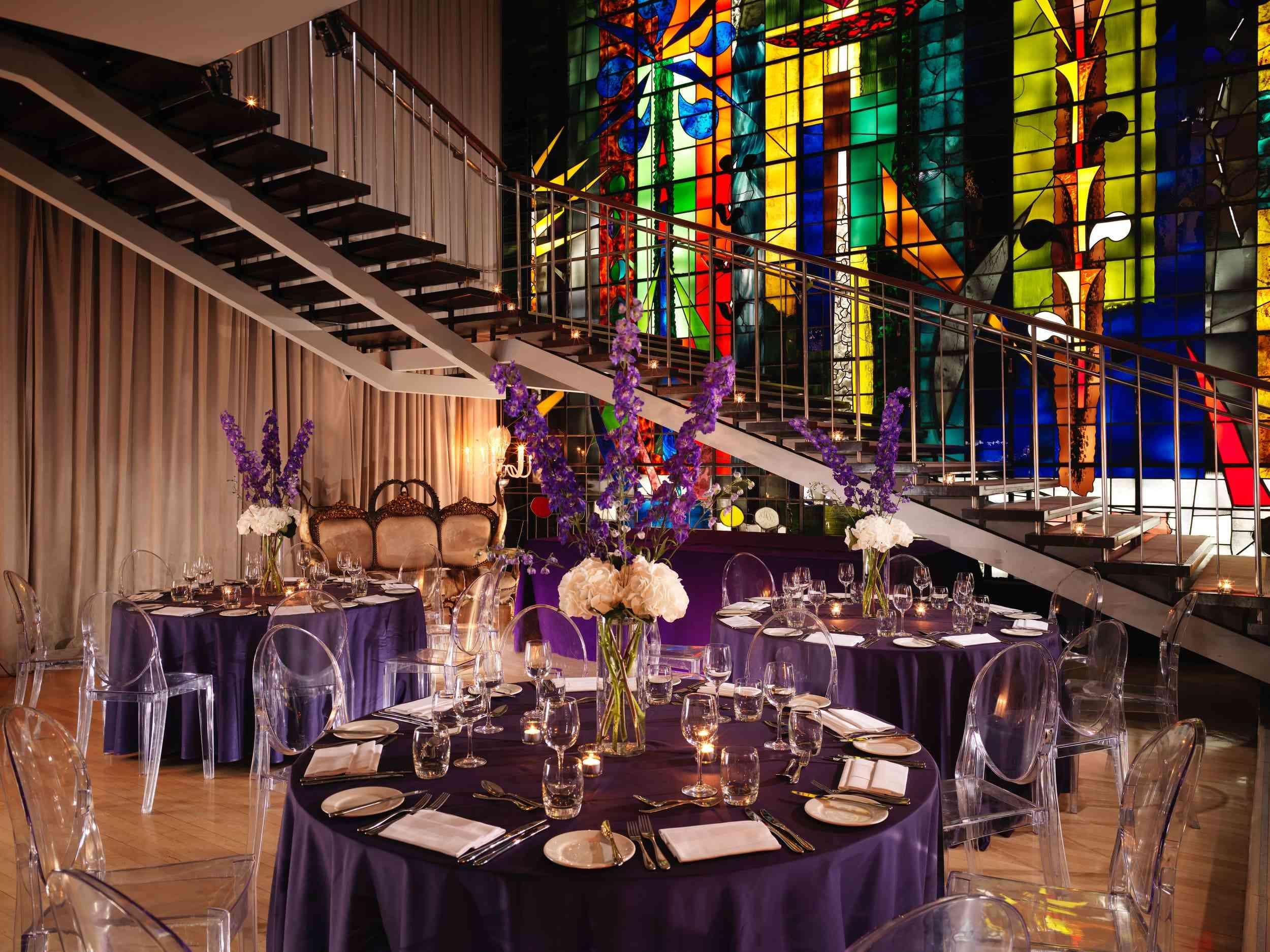 room with large stained glass window set up for an event