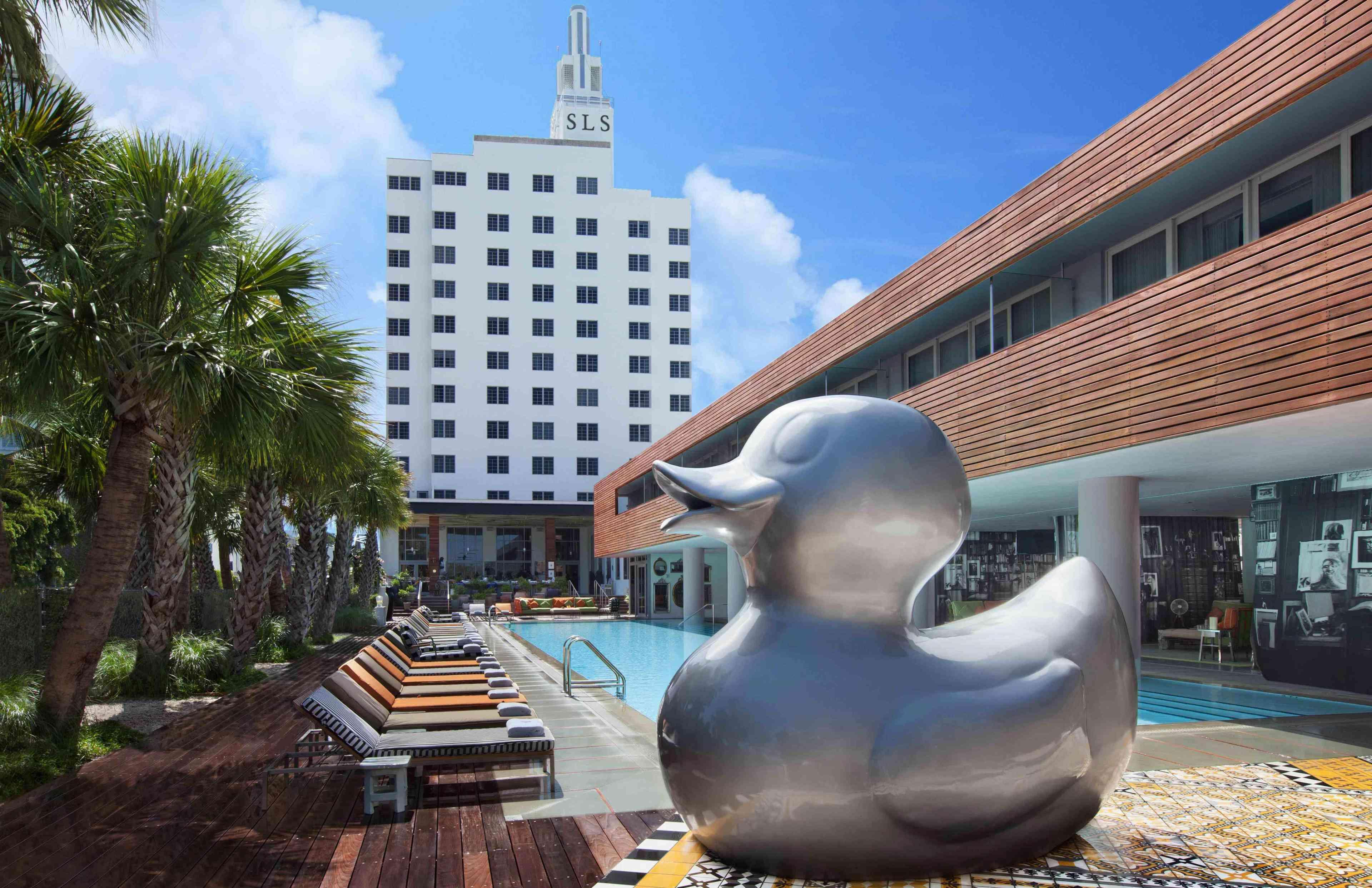 giant duck sculpture in front of pool 