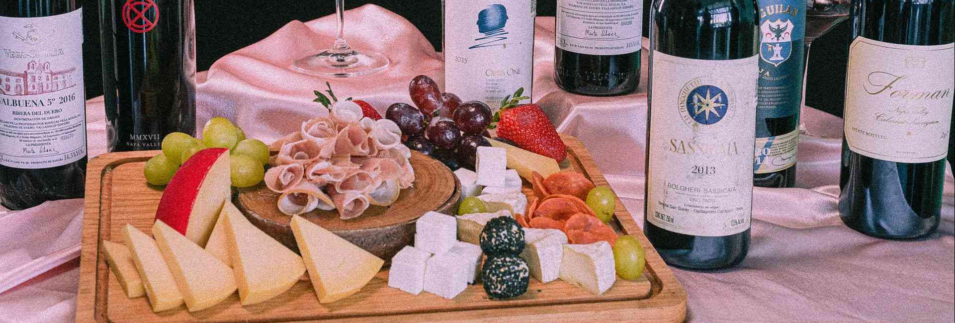 charcuterie board with bottles of wine 