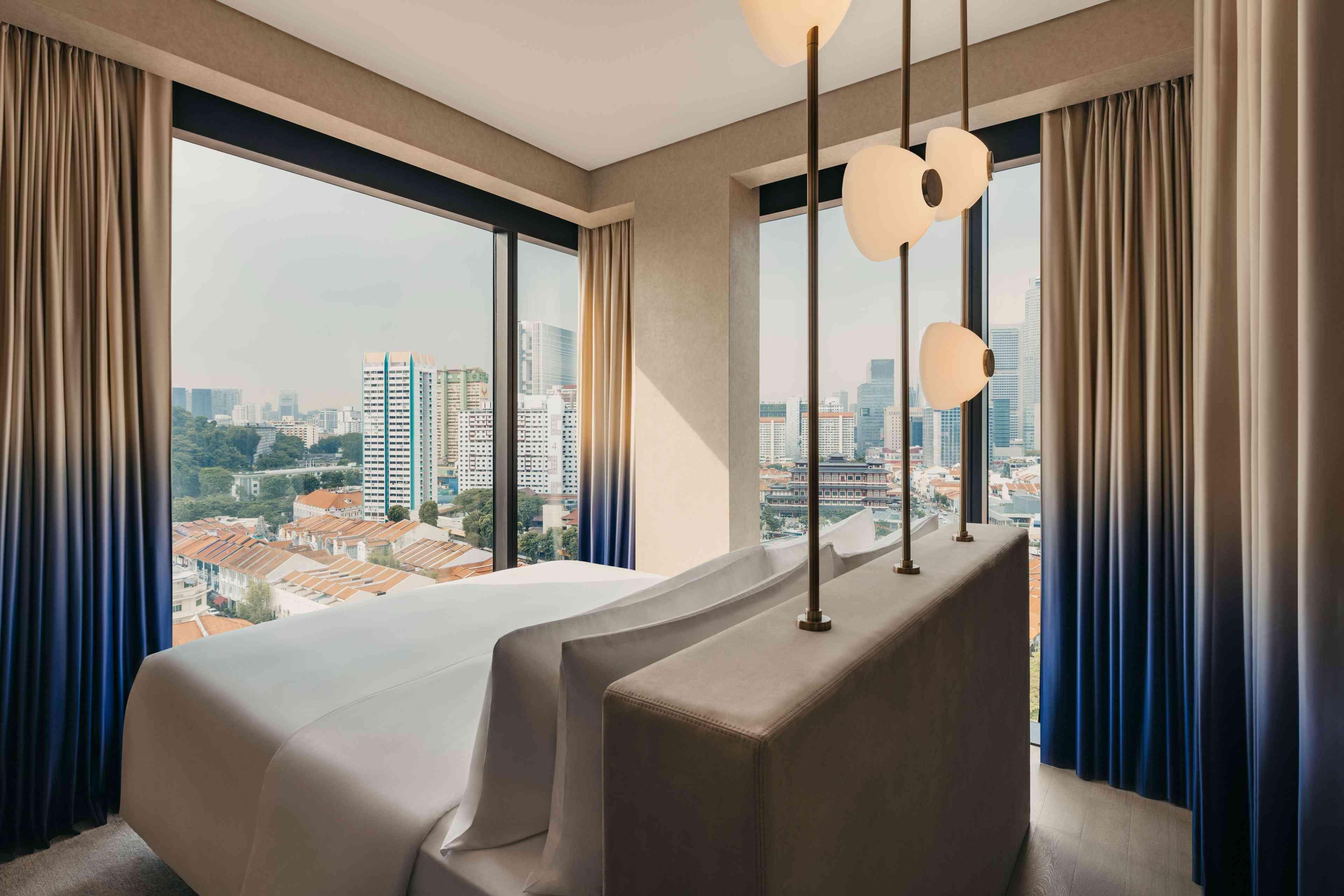 Suite at Mondrian Singapore Duxton with floor to ceiling windows overlooking the city. 