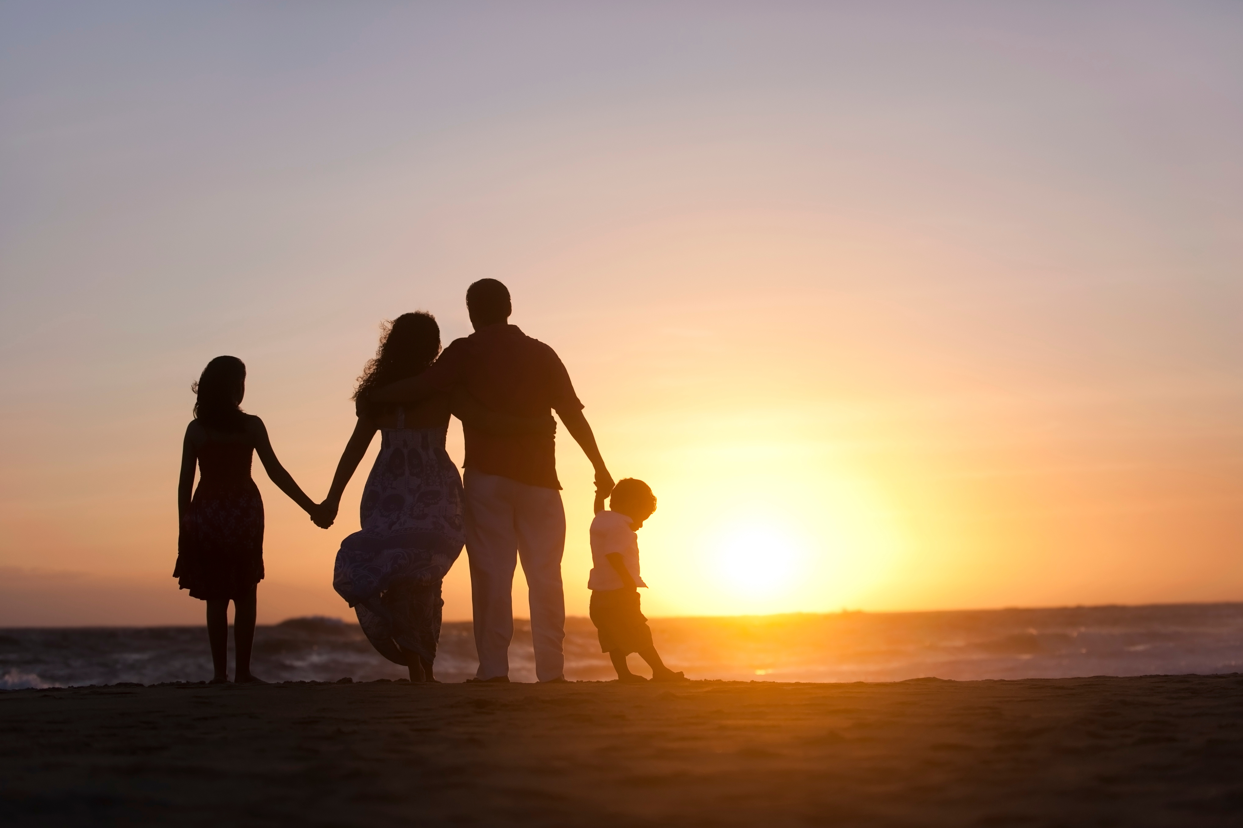 Family on beach during a sunset