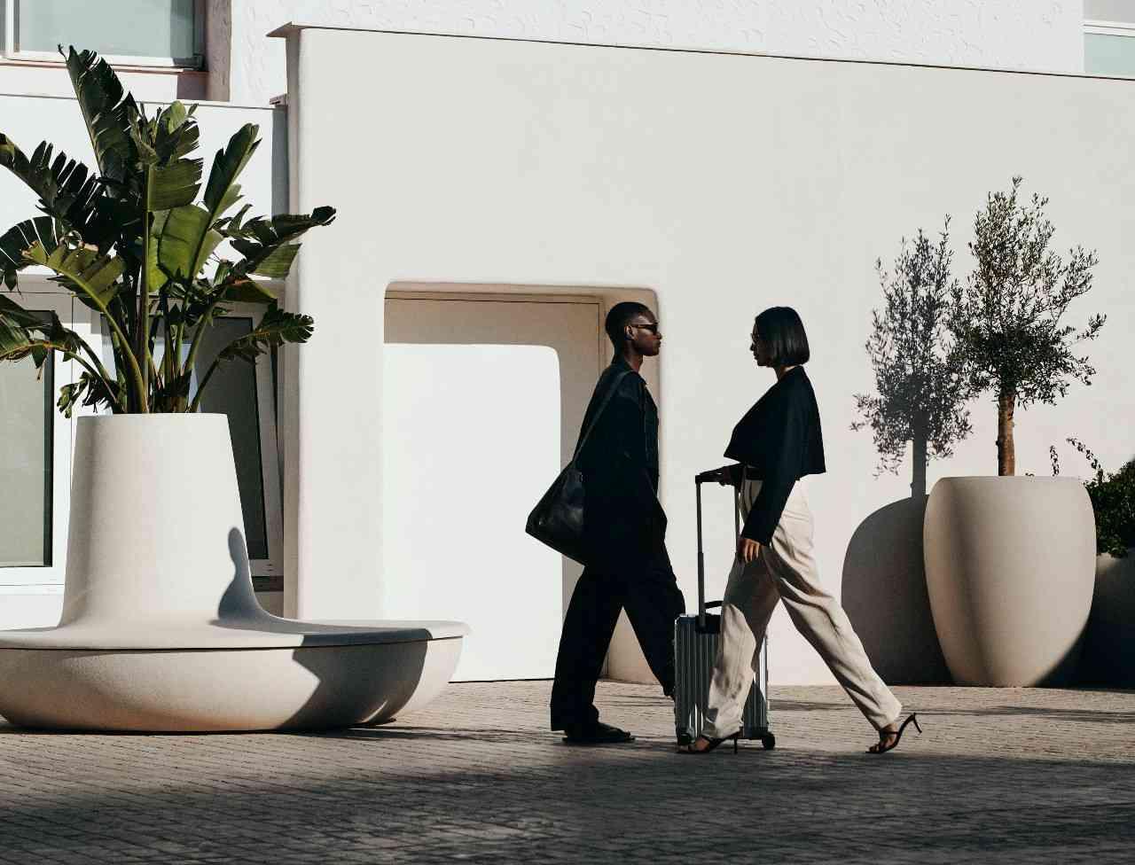 two people walking outside wearing black and white