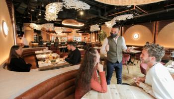 a server at a table in a restaurant