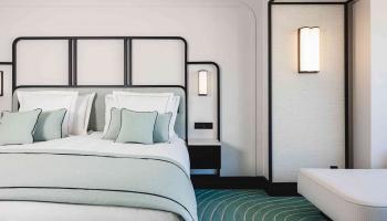 Modern room with light green and white linens. 