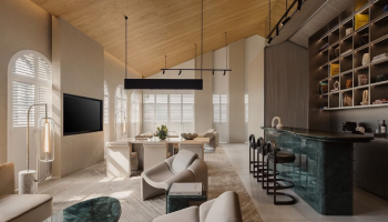 Mondrian Singapore's hotel living room featuring a bar area and a television.