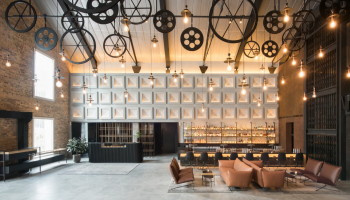 Mondrian Singapore lobby with a grand clock, exuding elegance and sophistication. The clock stands out as the focal point of the room.