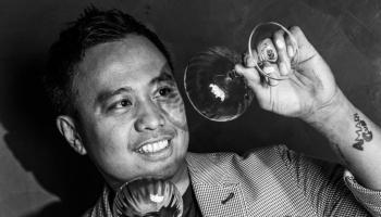 man cleaning a cocktail glass