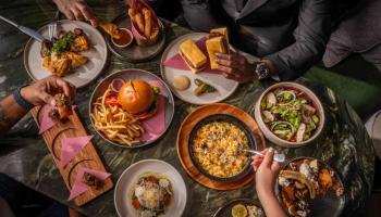 People sharing food over a table 